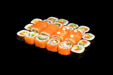 Japanese food: maki and nigiri sushi set on black background. side view composition.