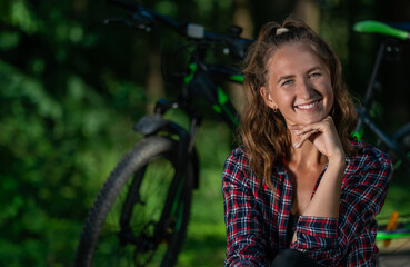 Portrait of a cheerful young woman in a shirt looking at the camera against the background of a...