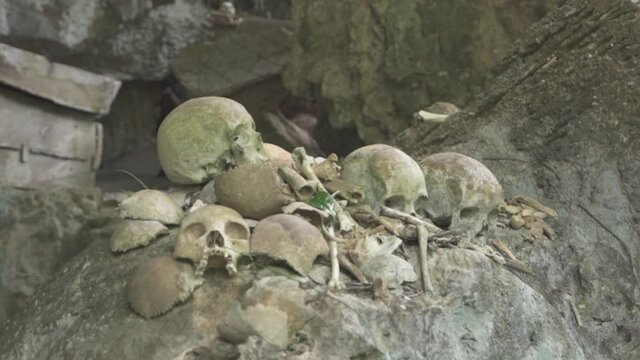 Tampang Allo, Tana Toraja, Indonesia - Tau Tau Human Skulls Piles of Bones Burial Graves Cave