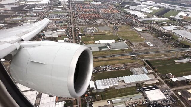 Airplane wing view after takeoff in a left turn