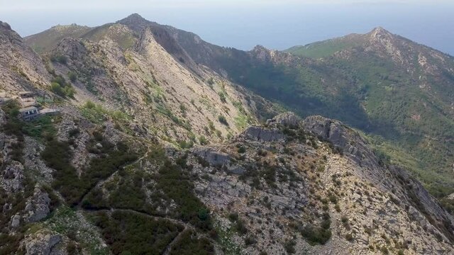 Aerial Drone video of mountain landscape around Monte Campanne highest mountain on Isola d'Elba on a sunny summer day, Italy