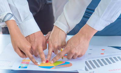 businees people pointing finger at sales target pie chart