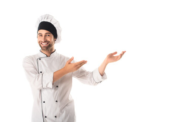 Cheerful chef pointing with hands isolated on white