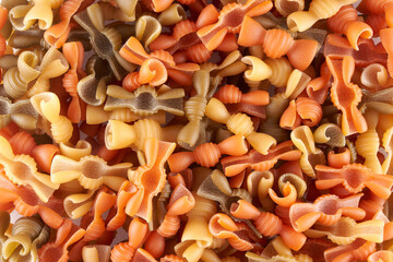 Assorted varieties of pasta background. Mix macaroni of different colors