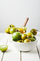 Green zebra tomatoes in a bowl.