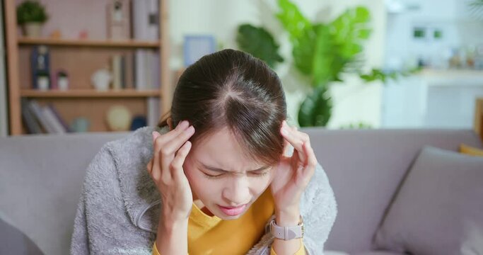 woman has headache at home