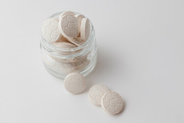 round tablets vitamins a lot in a jar scattering