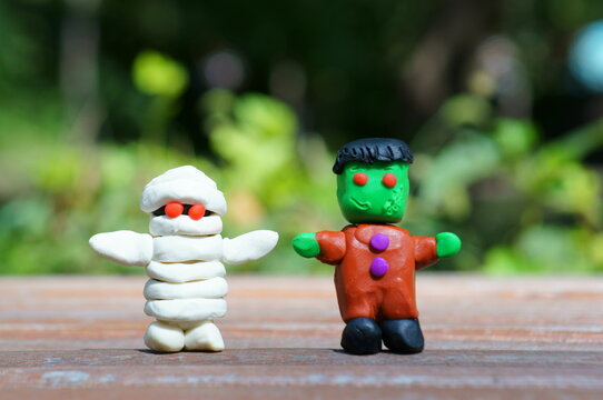 Funny Frankenstein and a plasticine mummy close-up. Figures of monsters. The concept of Halloween.