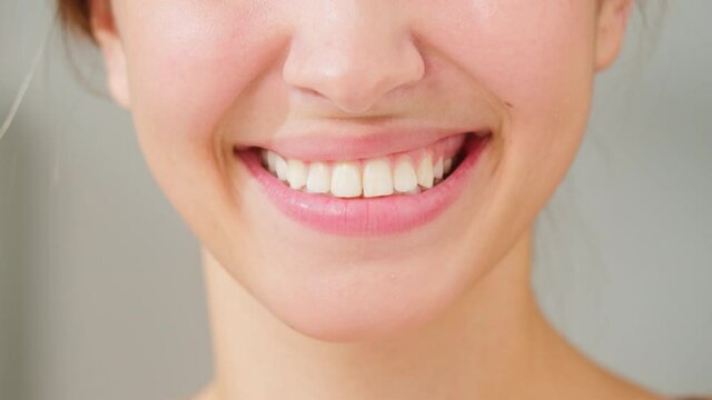 Wide female smile, white teeth close-up. Young woman smiling mouth portrait, businesswoman showing her teeth closeup. Dentistry and orthodontics concept. 