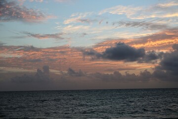 Beautiful yellow sunset over the ocean and different color sky