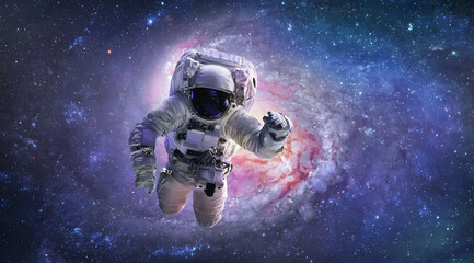 Astronaut in bright outer space. Galaxy and nebula. Galactic sci-fi wallpaper. Spaceman. Elements...
