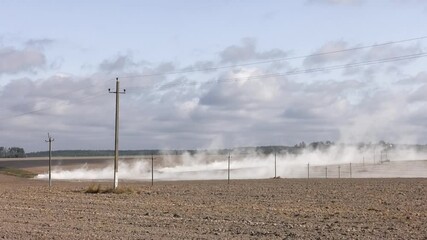 Farmer preparing land with seedbed cultivator as part of pre seeding activities in early spring season. 
