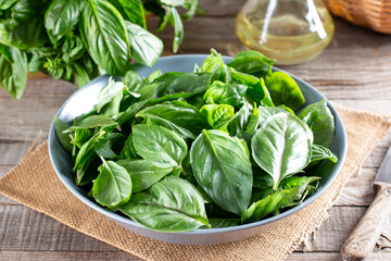 Fresh basil leaves on a cutting board on a table. Concept of healthy eating.