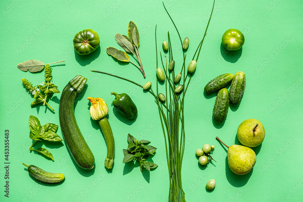 Wall mural green vegetables on the green background