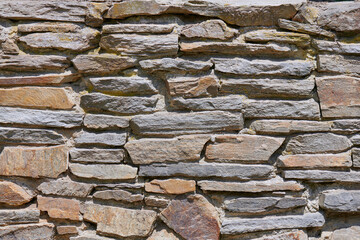 Stone wall built of sandstone in the national park, nature reserve, villages, meadows. - obrazy, fototapety, plakaty