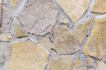 Texture of brown stones laying in pieces. Covering the walls with natural stones