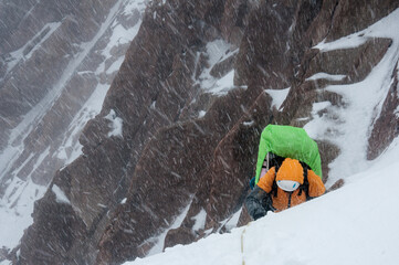 A climber during a storm in the mountains