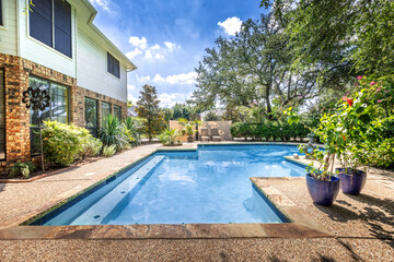 Backyard oasis with a swimming pool inside a private residential backyard - 453363450