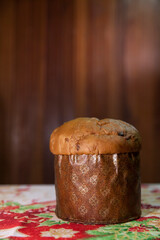 Panettone on the table with a Christmas tablecloth. Panettone concept. Christmas concept. copy space.
