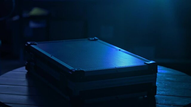 Placing briefcase on table in blue light