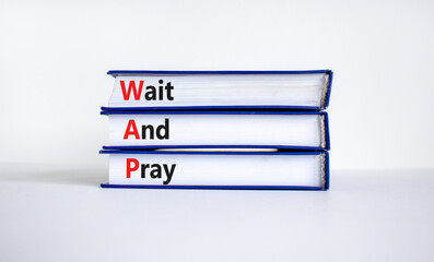 WAP, Wait and pray symbol. Books with concept words 'WAP, Wait and pray'. Beautiful white...