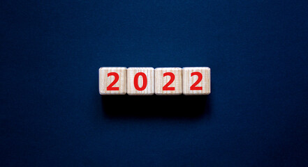 2022 happy new year symbol. Wooden cubes symbolize the change from 2021 to the new year 2022....