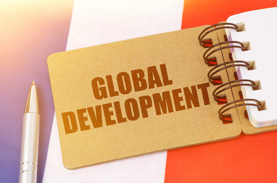 On the flag of France lies a notebook with the inscription - Global development