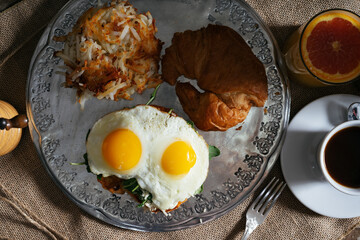 croissant egg sandwich hash brown juice