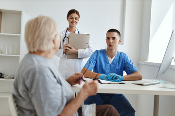 elderly woman patient at doctor's appointment and nurse in office