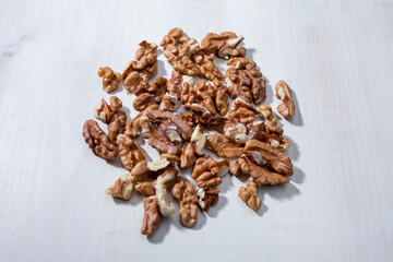 walnut halves on white wooden background