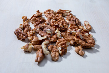 walnut halves on white wooden background
