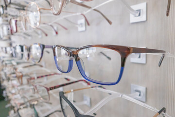 glasses at an opticians, eyeglasses shop, stand with glasses in the store of optics, eyesight correction.