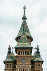 Fototapeta na wymiar Characteristic towers with green tiles of the Metropolitan Cathedral of Timisoara in Romania