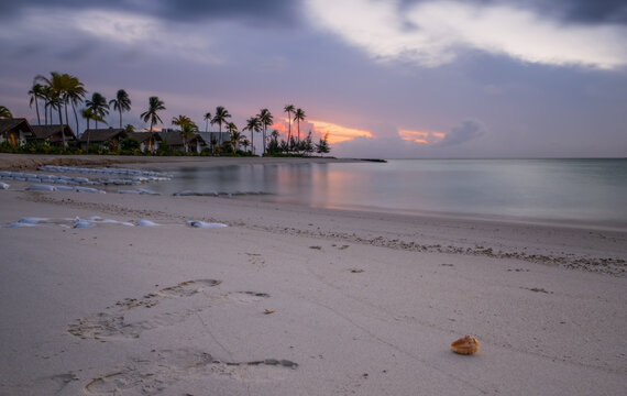 Beautiful vivid sunrise over beach with the villas in the Indian ocean, Maldives. Crossroads Maldives, july 2021. Long exposure picture