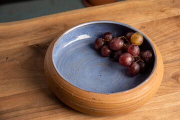 piece of grapes in a ceramic design plate