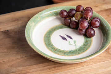 piece of grapes in a ceramic design plate