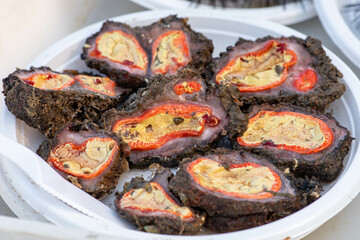 Opened by hand raw microcosmus sabatieri, grooved sea squirt, truffle, lemon or egg sea, fig, sponge ready to eat in a plate in a fish market, sea fruits, sushi