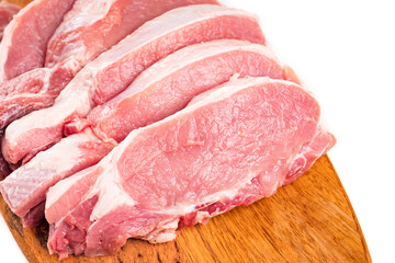chopped into pieces raw pork on a wooden cutting board on a white background.