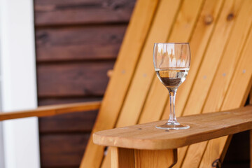 Glass of White Wine on a Wooden Chair. Copy Space