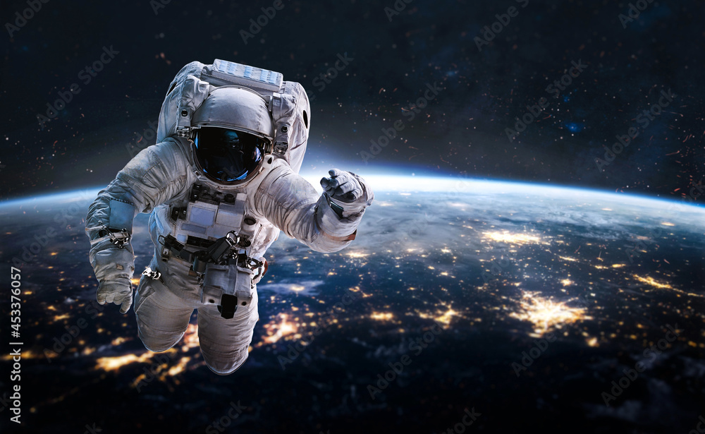 Fototapete Astronaut in outer deep space on orbit of Earth planet. Dark space and spaceman.Earth at night. Elements of this image furnished by NASA