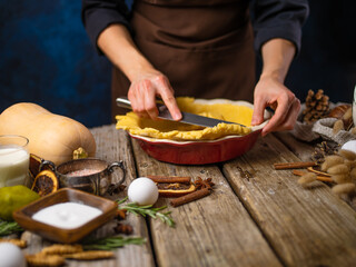 The chef puts the dough into an American pumpkin pie baking pan. An old traditional recipe. Lots of ingredients. Country style. Restaurant, hotel, homemade pastries, step by step recipe.