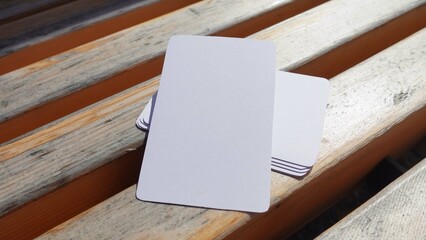Blank playing card mock up. Deck of white cards on a wooden background