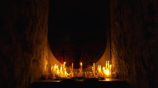 Occult stent with pentagram surrounded by candles in the dark