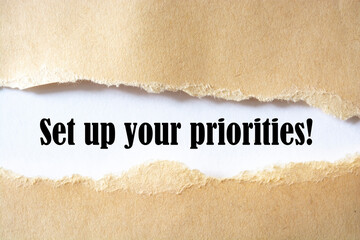 Set up your priorities message written under torn paper. Business,