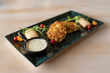 Potato pancakes with fried squid. The main ingredient for potato pancakes is potatoes 
