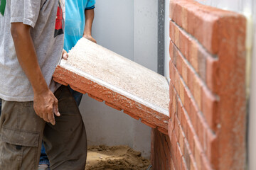 Thai Labour are installed Foam brick board on the cement wall