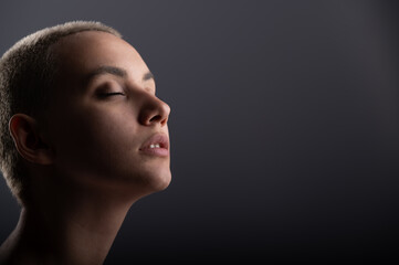 Portrait of pensive young woman with short hair on white background. Copy space