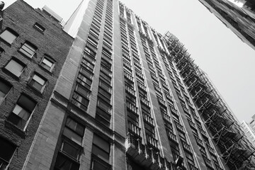 black and white building shot from below with fire escape