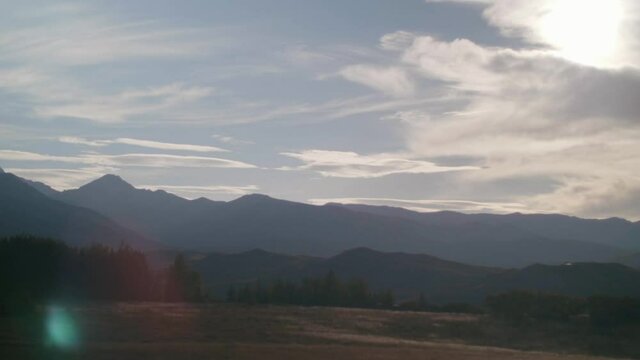 Time lapse of sun setting behind the mountains. 