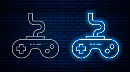 Glowing neon line Gamepad icon isolated on brick wall background. Game controller. Vector
